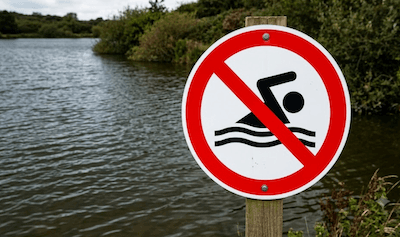 Hands reaching up from water — drowning