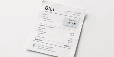 A paper bill showing a total amount due