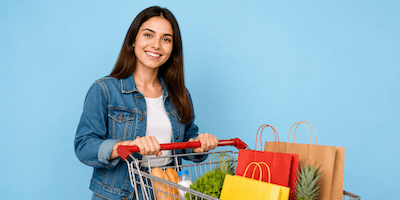 A woman with a shopping cart full of purchases