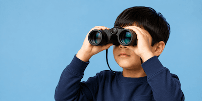 A boy looking through binoculars