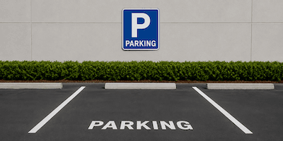 A parking space sign painted on the ground
