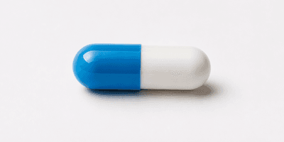 A blue and white capsule pill